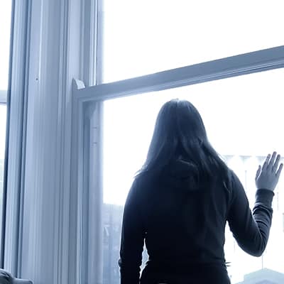 A woman looking out of a window.