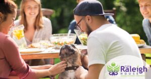 Family and friends enjoy a picnic outside.