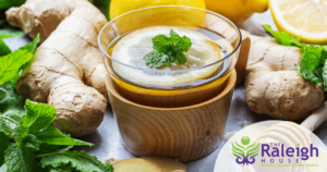 A mug of ginger tea with lemon, mint and honey. 