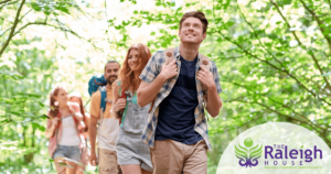 A group of four young adults goes for a hike as they discuss sober activities.