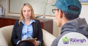 A patient looks contemplative during a session with his therapist.