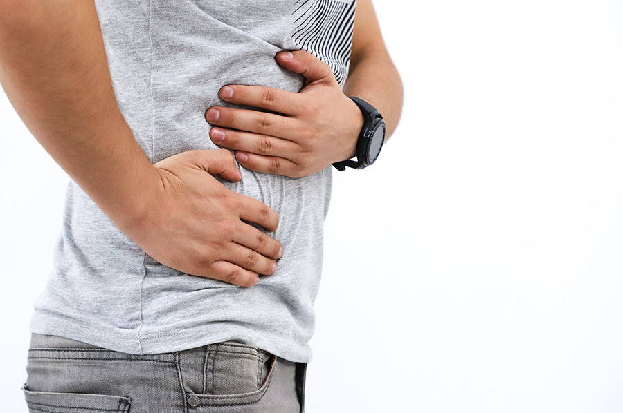 man holding hands over liver