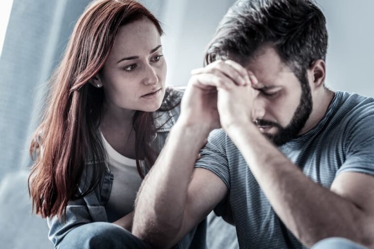 Woman comforting an emotionally distressed man.