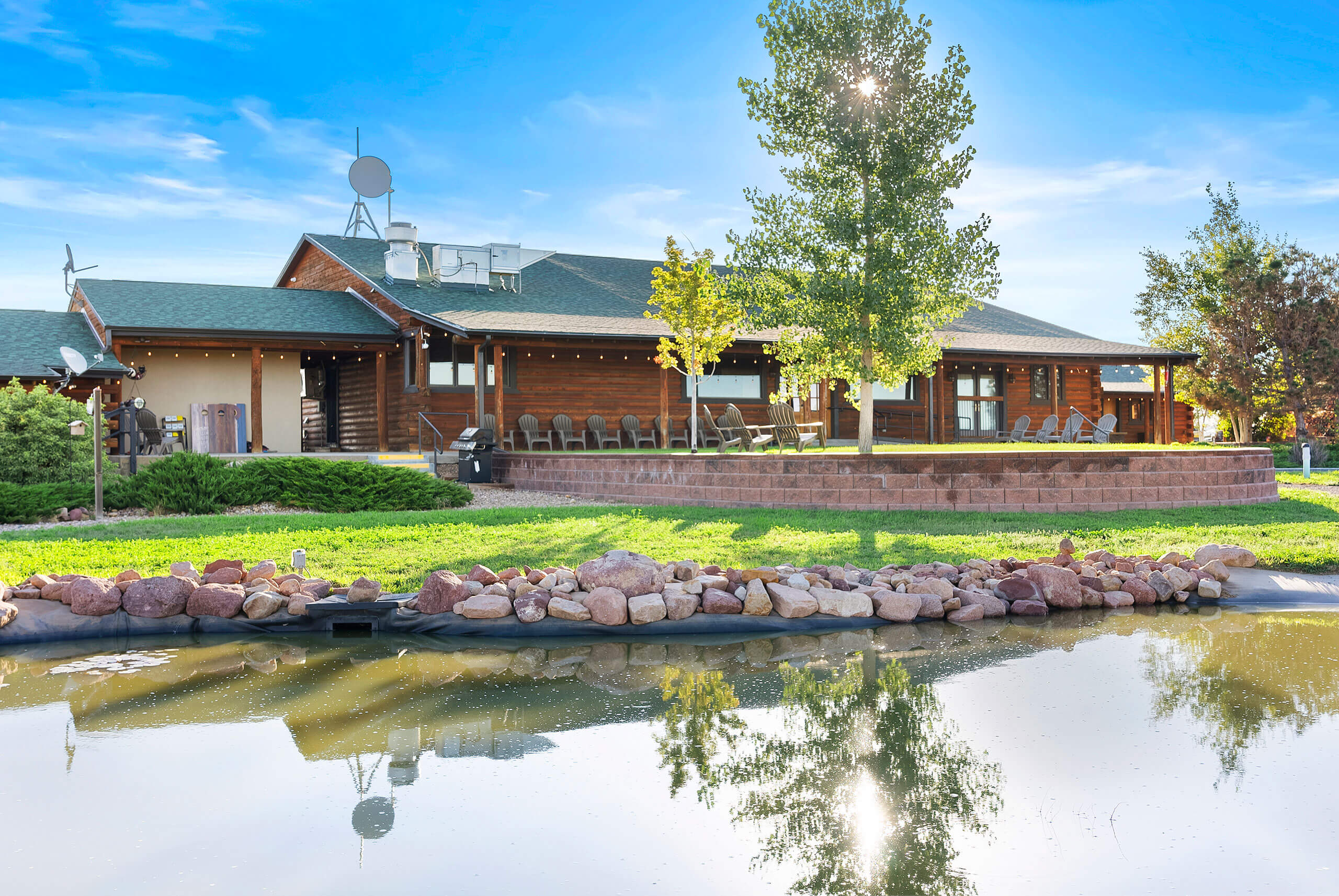View of the cabin and pond at The Ranch