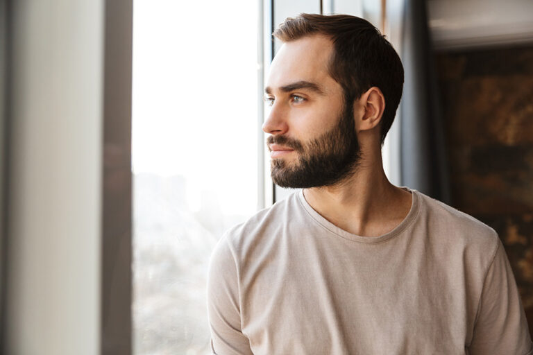 Young man staring out the window