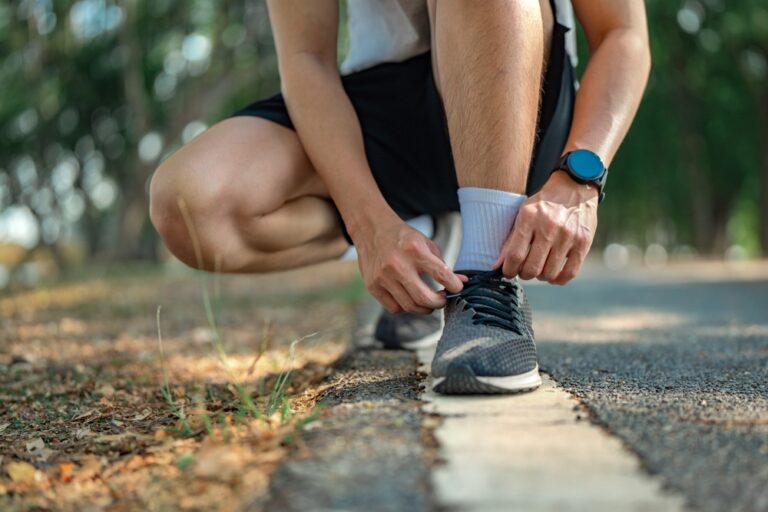 Person tying running shoe