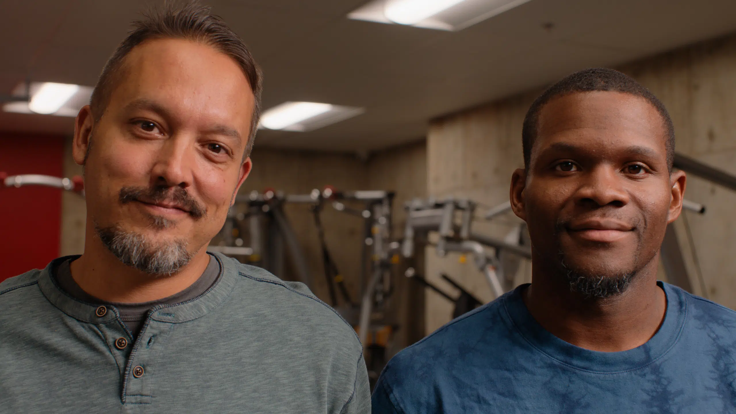 close up of 2 men in a gym