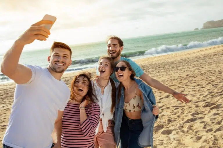 Group of friends taking a selfie at the beach