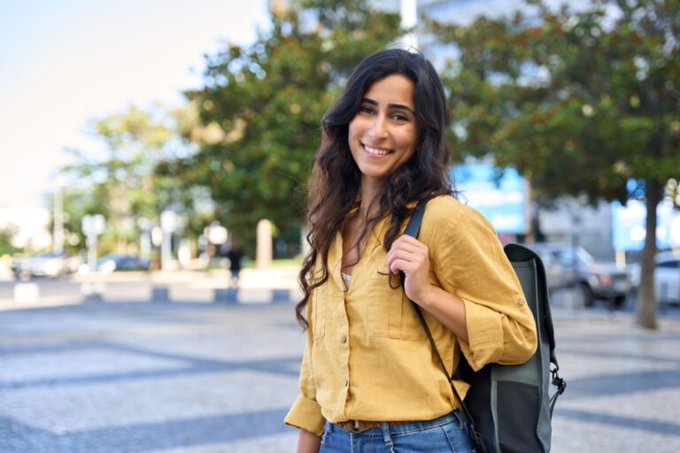 Woman outside with a backpack in urban area