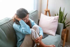 stresssed woman sitting on couch 