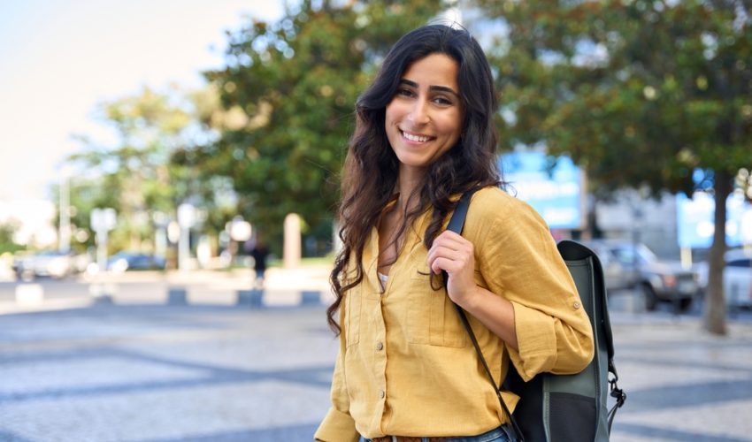 Woman outside with a backpack in urban area